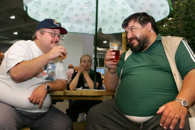 two men working on their beer bellies two men working on their beer bellies